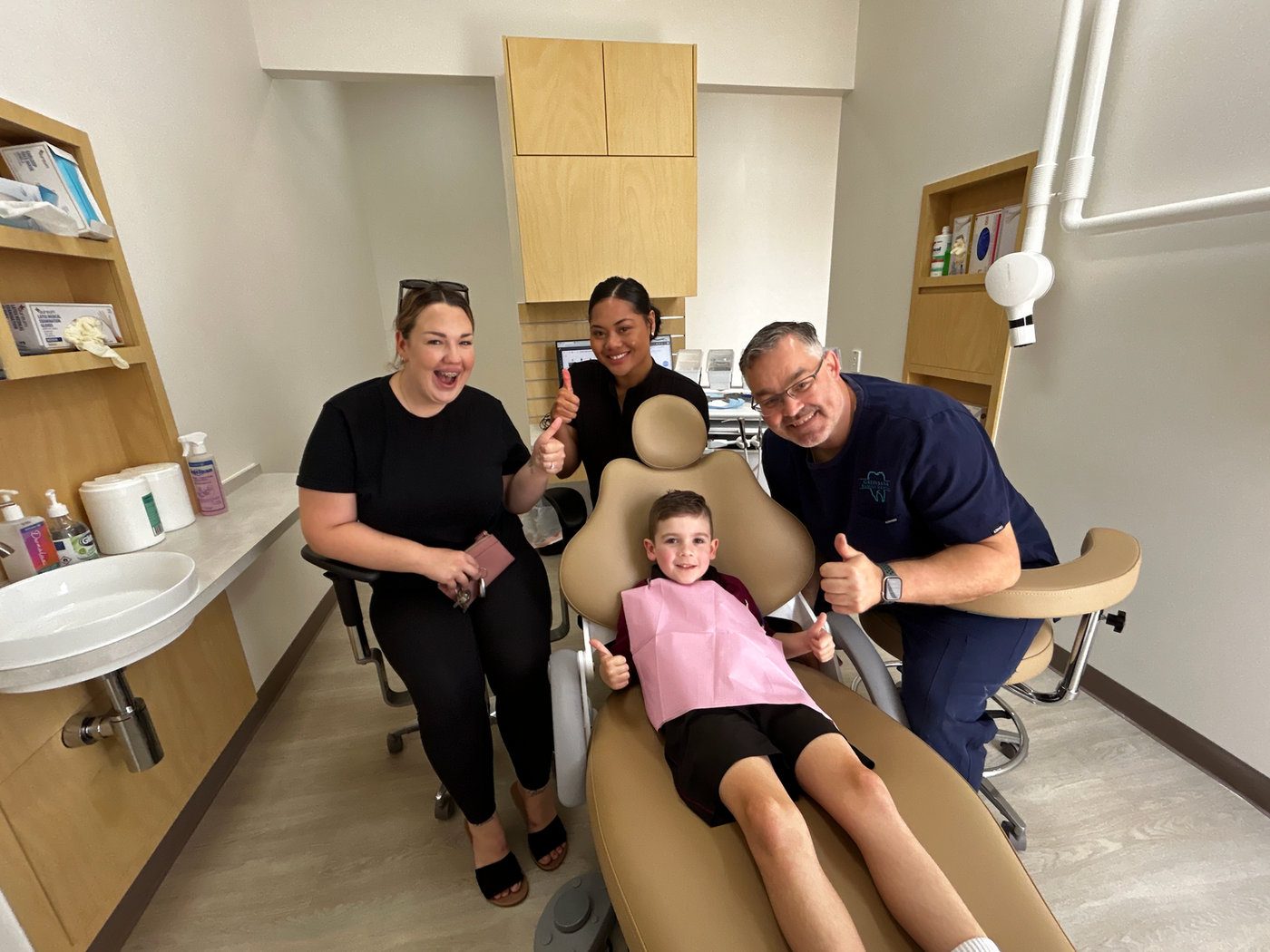 Dr Dan Holthe and the Greenbank Family Dental team with a young patient in a treatment room at the new Old Pub Lane clinic